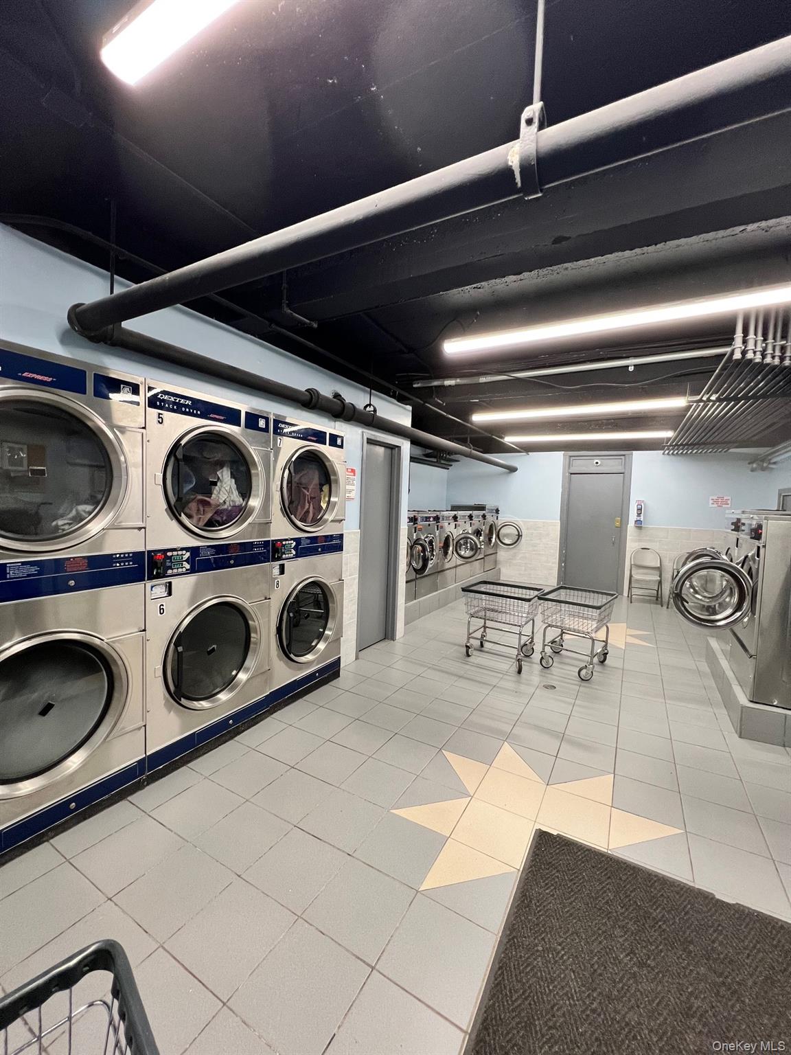 67-35 Yellowstone Boulevard, Unit 7E Queens, NY 11375 - Photo 5 of 16 a utility room with dryer and washer