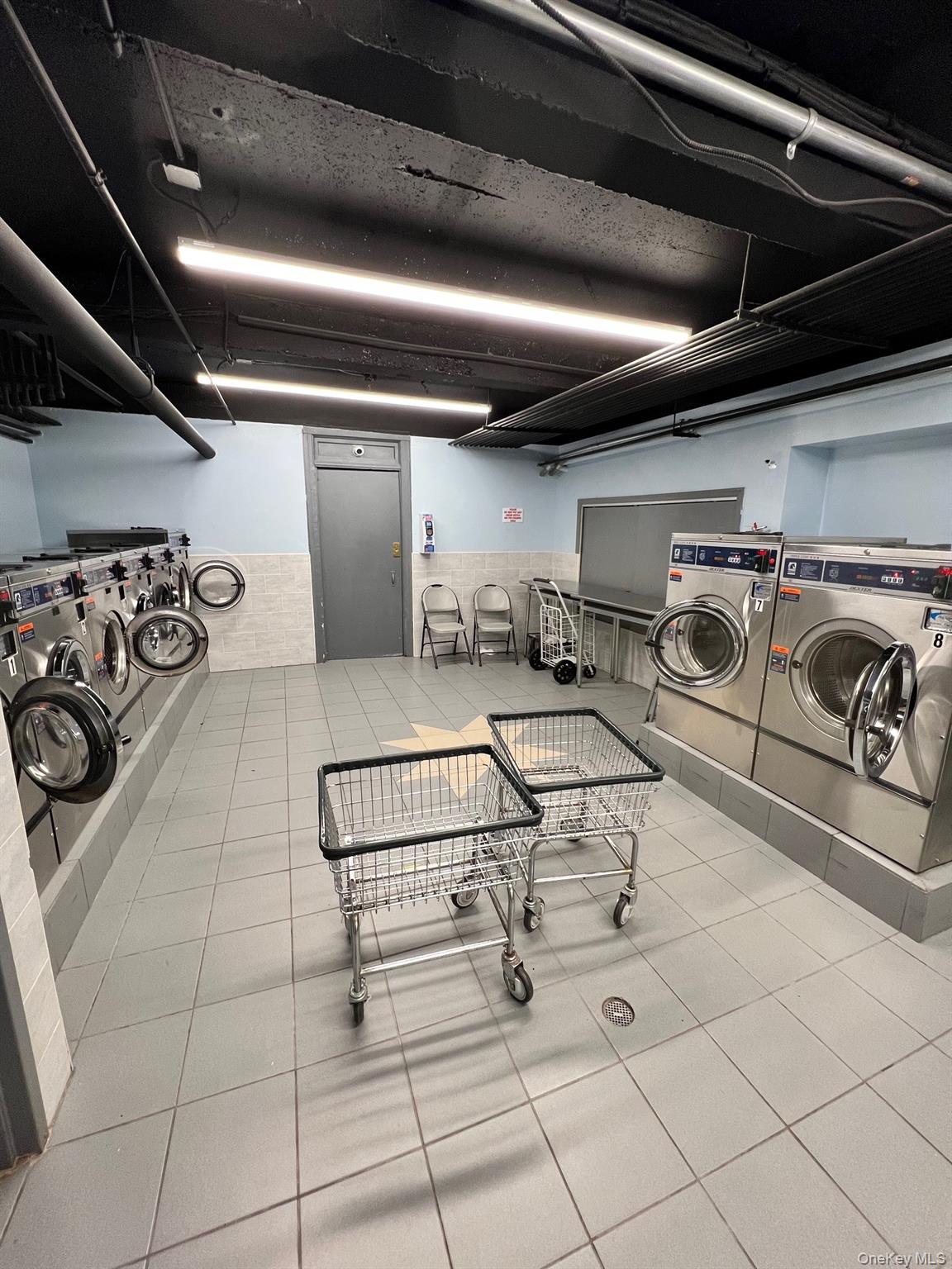 67-35 Yellowstone Boulevard, Unit 7E Queens, NY 11375 - Photo 6 of 16 a view of parking garage with stove and racks