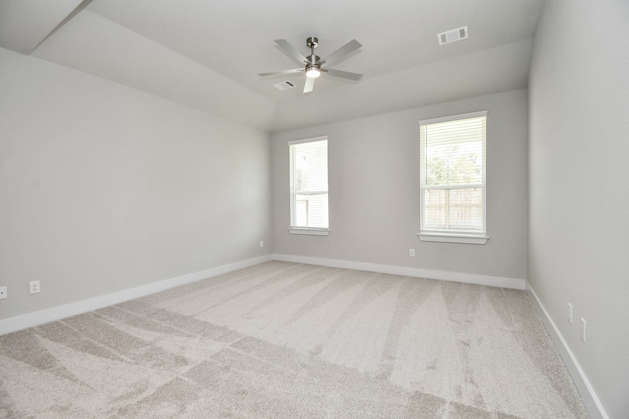 3038 Native Spg Drive Spring, TX 77373 - Photo 20 of 40 Come and unwind after a long day in this magnificent primary suite! This spacious room features plush carpet, warm paint, high ceilings and large windows with privacy blinds. Sample photo of completed home with similar floor plan. Actual colors and selections may vary.