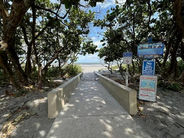 a view of a balcony with wooden floor and fence