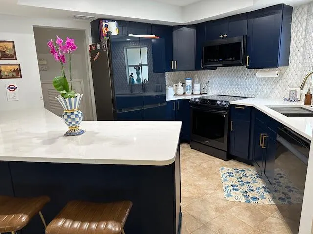 a kitchen with a sink refrigerator and microwave
