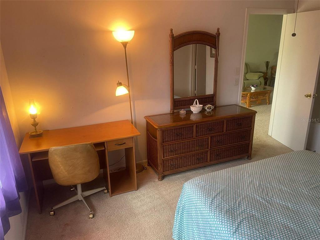 26485 Rampart Boulevard, Unit A27 Punta Gorda, FL 33983 - Photo 11 of 19 a bedroom with a bed and furniture