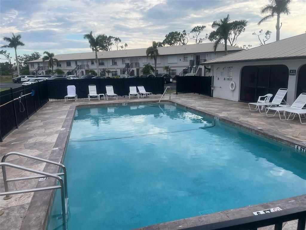 26485 Rampart Boulevard, Unit A27 Punta Gorda, FL 33983 - Photo 2 of 19 a view of a balcony with furniture and flat screen tv