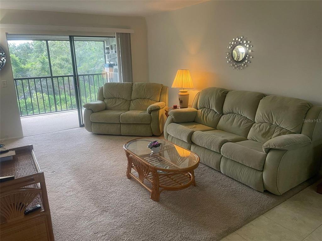 26485 Rampart Boulevard, Unit A27 Punta Gorda, FL 33983 - Photo 3 of 19 a living room with furniture and a window