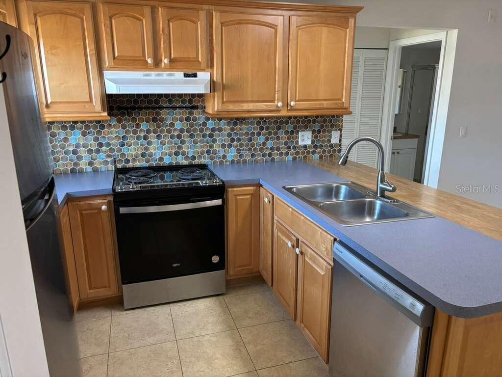 26485 Rampart Boulevard, Unit A27 Punta Gorda, FL 33983 - Photo 5 of 19 a kitchen with a sink and a stove
