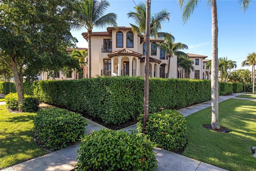 1012 7th Street South, Unit B2 Naples, FL 34102 - Photo 1 of 17 a front view of a house with a yard