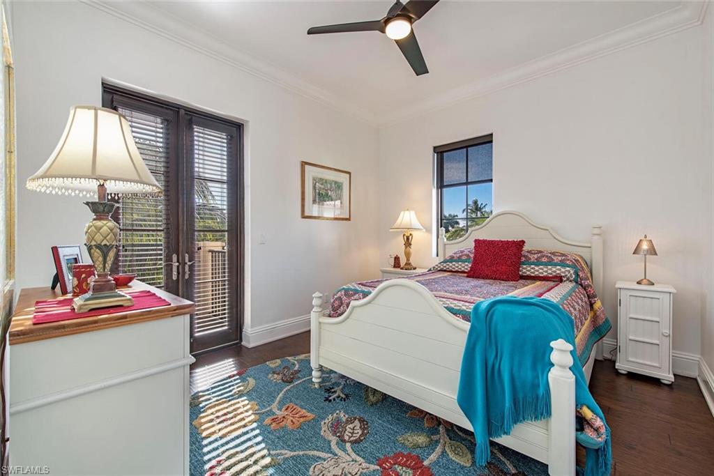 1012 7th Street South, Unit B2 Naples, FL 34102 - Photo 11 of 17 a bedroom with a bed and a dresser