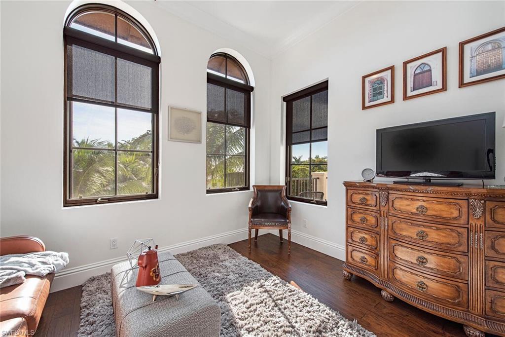 1012 7th Street South, Unit B2 Naples, FL 34102 - Photo 13 of 17 a living room with furniture and a flat screen tv