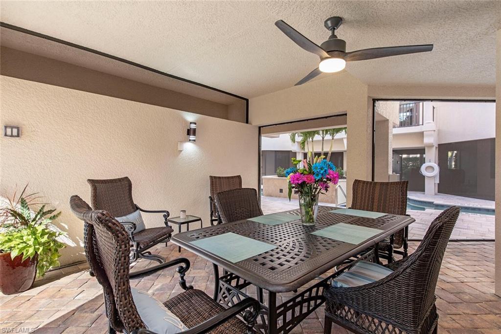 1012 7th Street South, Unit B2 Naples, FL 34102 - Photo 16 of 17 a view of a dining room with furniture and a potted plant