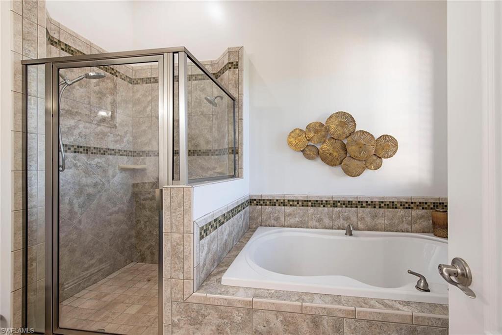 1012 7th Street South, Unit B2 Naples, FL 34102 - Photo 10 of 17 a bathroom with a tub and a shower