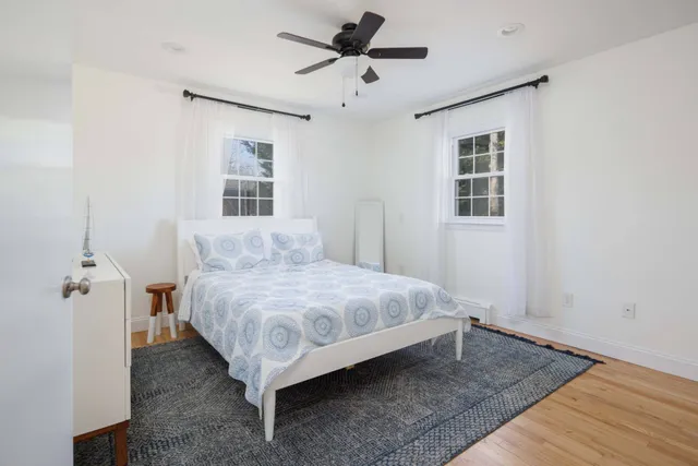 a spacious bedroom with a bed and a window