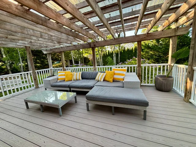 a view of backyard with table and chairs under an umbrella