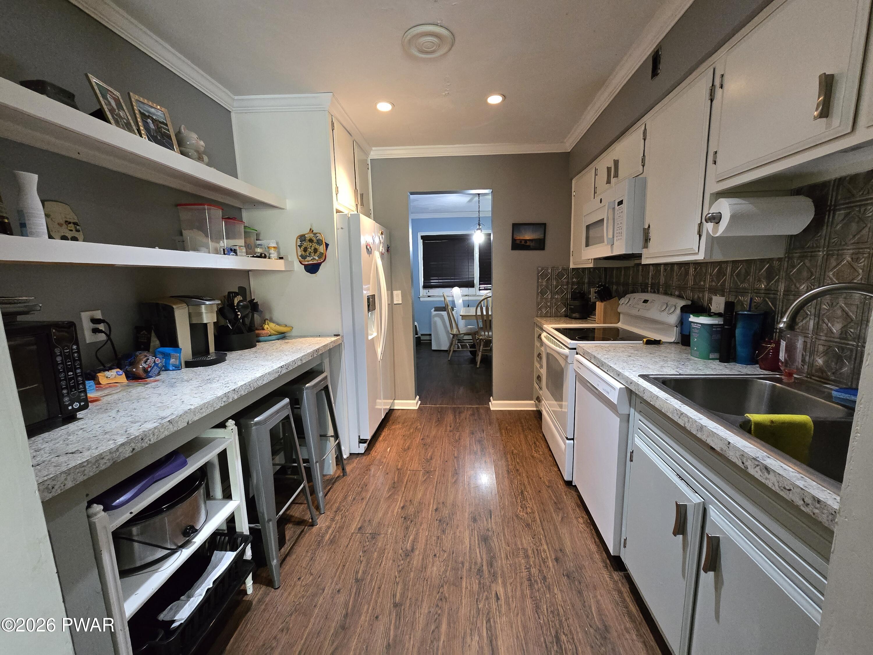 107 Keystone Hls Road, Unit 404 Factoryville, PA 18419 - Photo 15 of 23 a kitchen with stainless steel appliances granite countertop a stove and a refrigerator