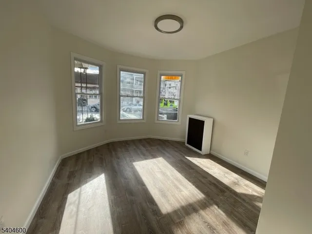 a view of wooden floor and windows in a room