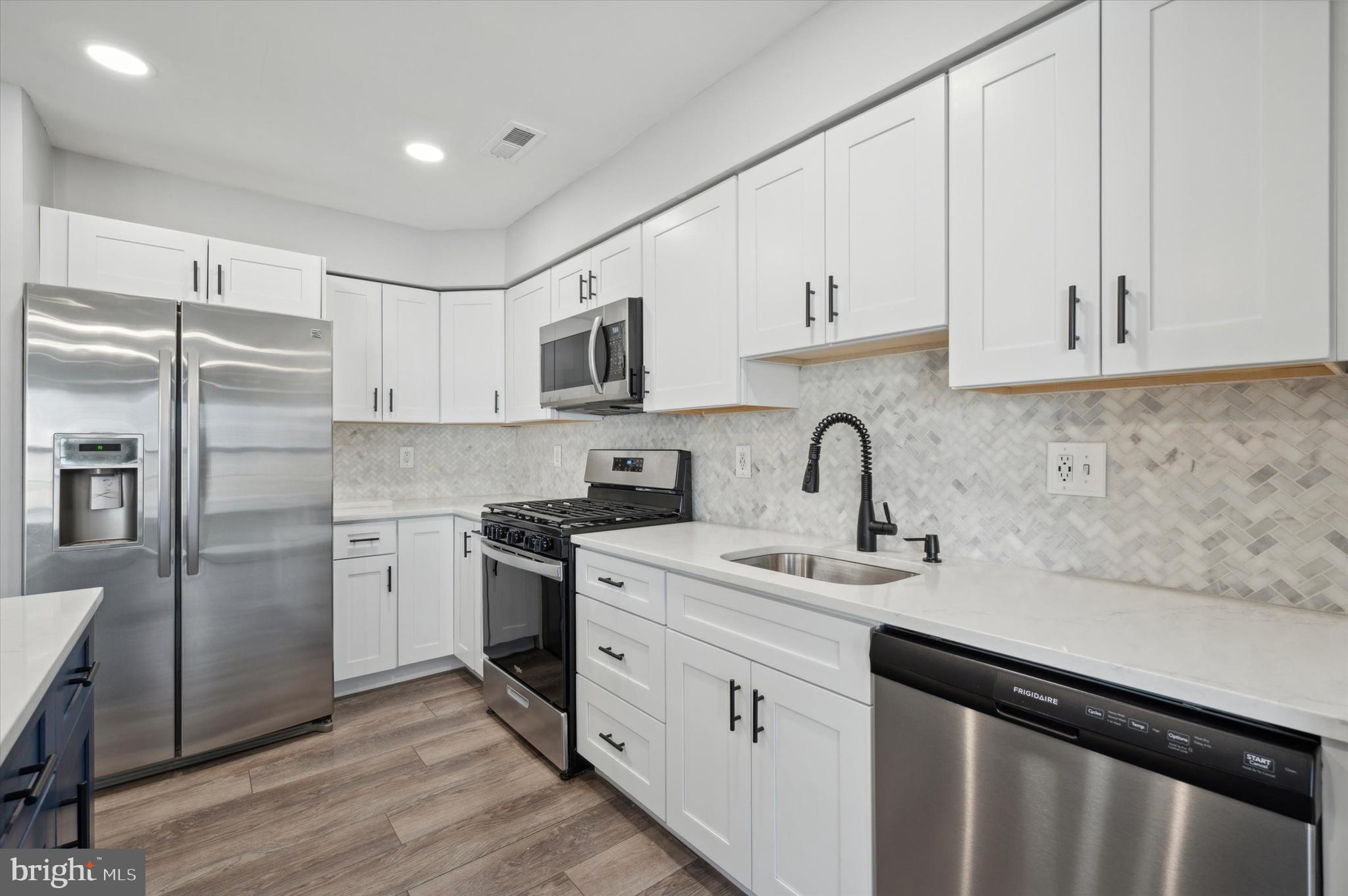 9 Meadow Lane Delran, NJ 08075 - Photo 5 of 15 a kitchen with white cabinets sink and stainless steel appliances