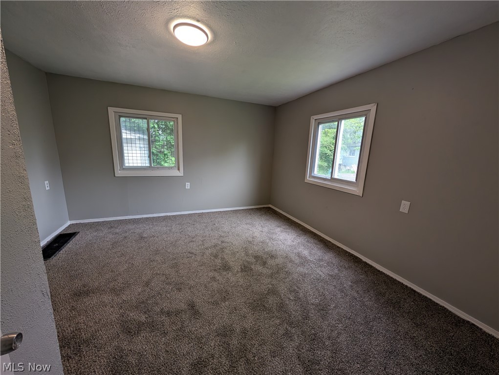 475 East 146th Street Cleveland, OH 44110 - Photo 18 of 28 Carpeted interior room with neutral gray walls and white trim