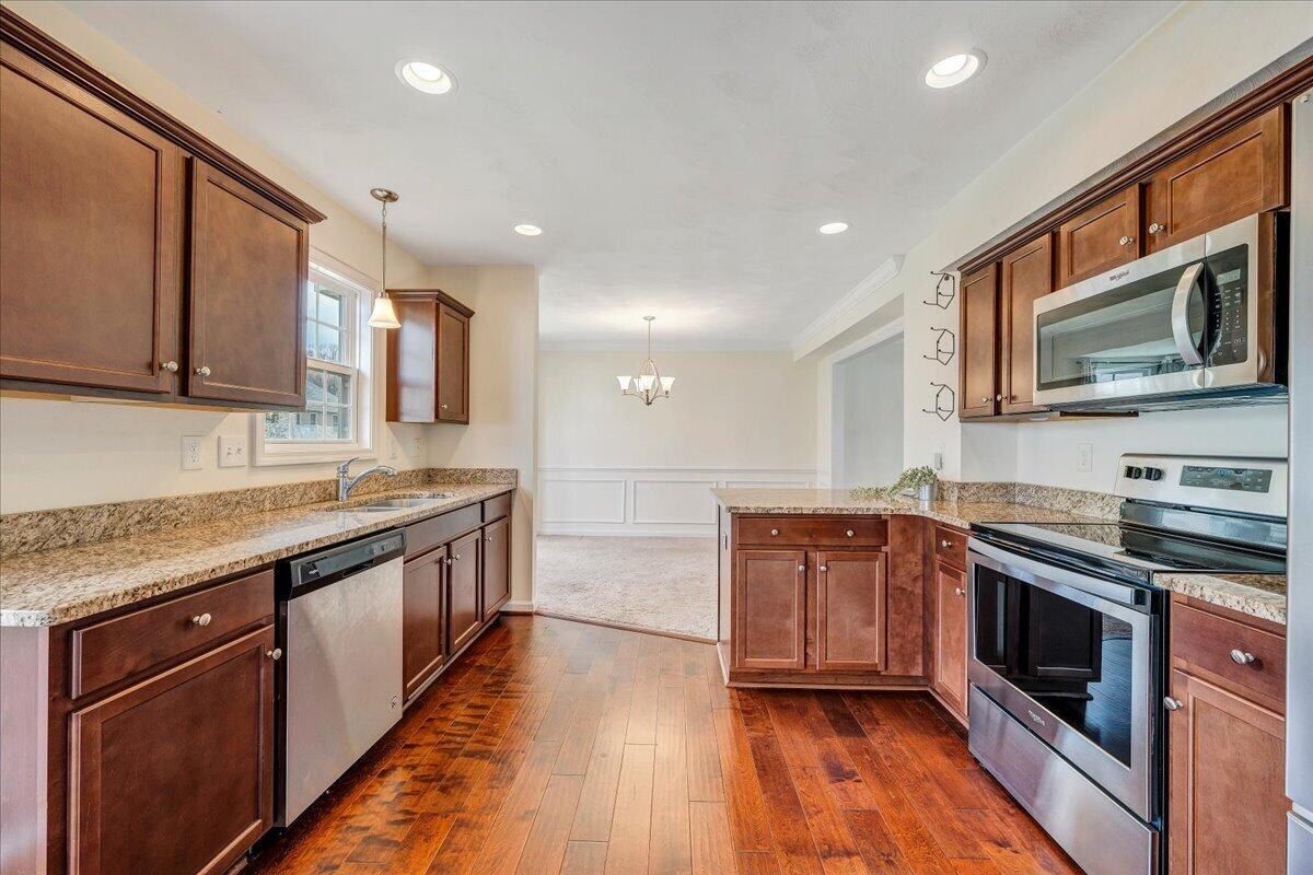 427 Cambridge Ct Road Vinton, VA 24179 - Photo 17 of 46 a kitchen with stainless steel appliances granite countertop wooden cabinets granite counter tops and a stove