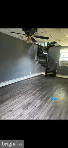 a view of a room with wooden floor
