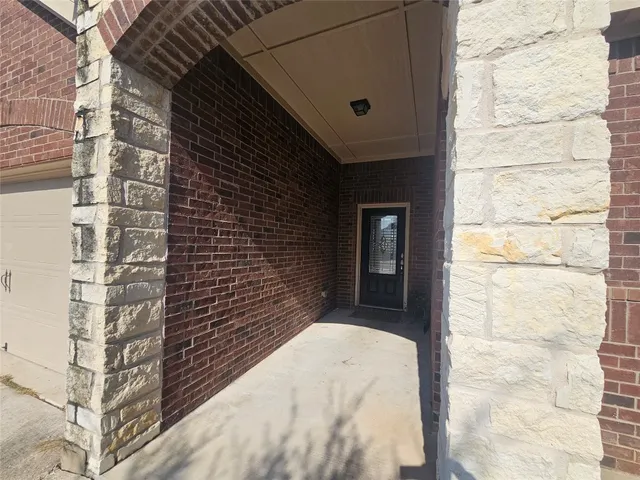 an empty room with a bathroom and a window