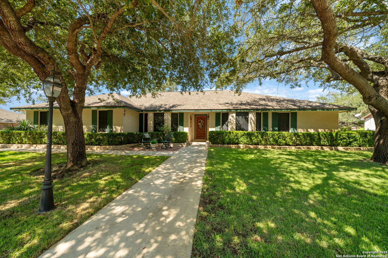 a front view of a house with a garden
