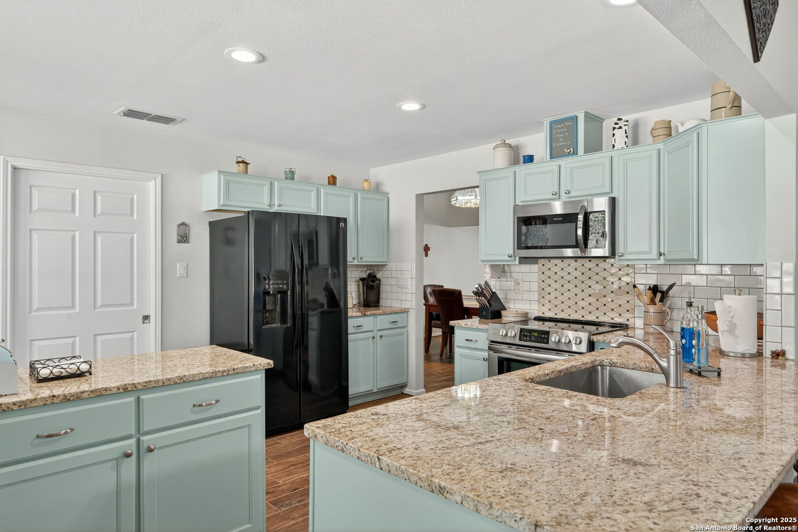 231 Hayden Road Pleasanton, TX 78064 - Photo 11 of 36 a kitchen with stainless steel appliances granite countertop a refrigerator sink and stove