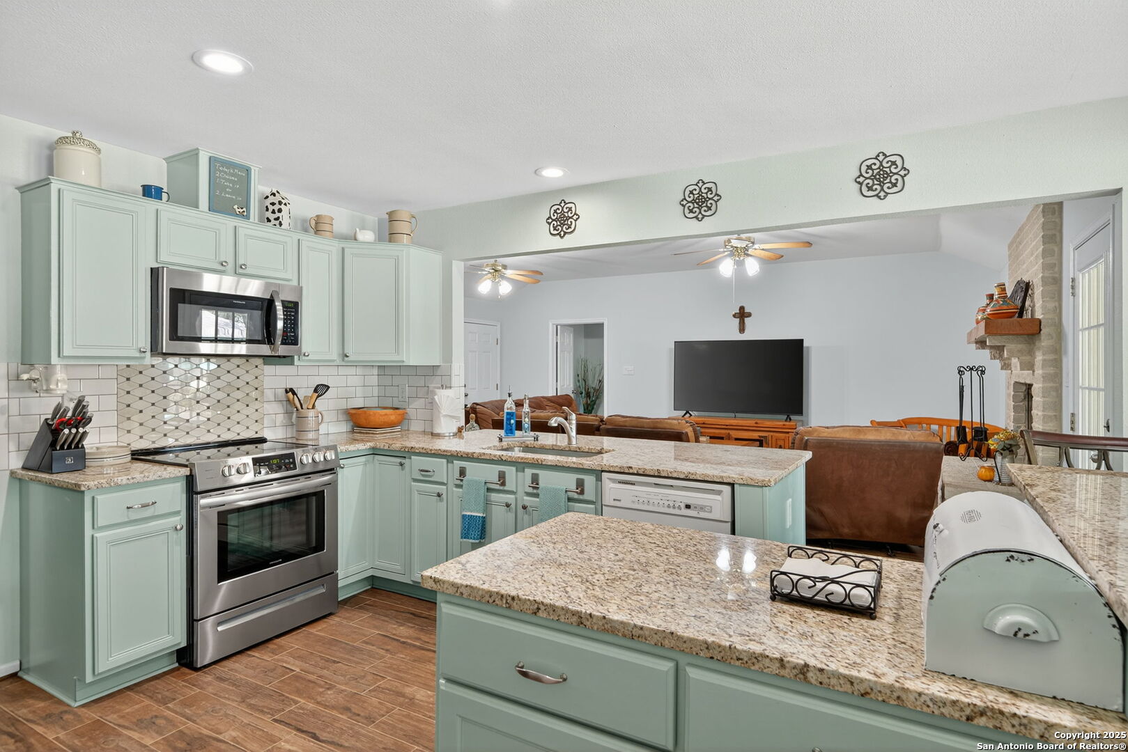 231 Hayden Road Pleasanton, TX 78064 - Photo 13 of 36 a kitchen with stainless steel appliances granite countertop a sink and stove top oven