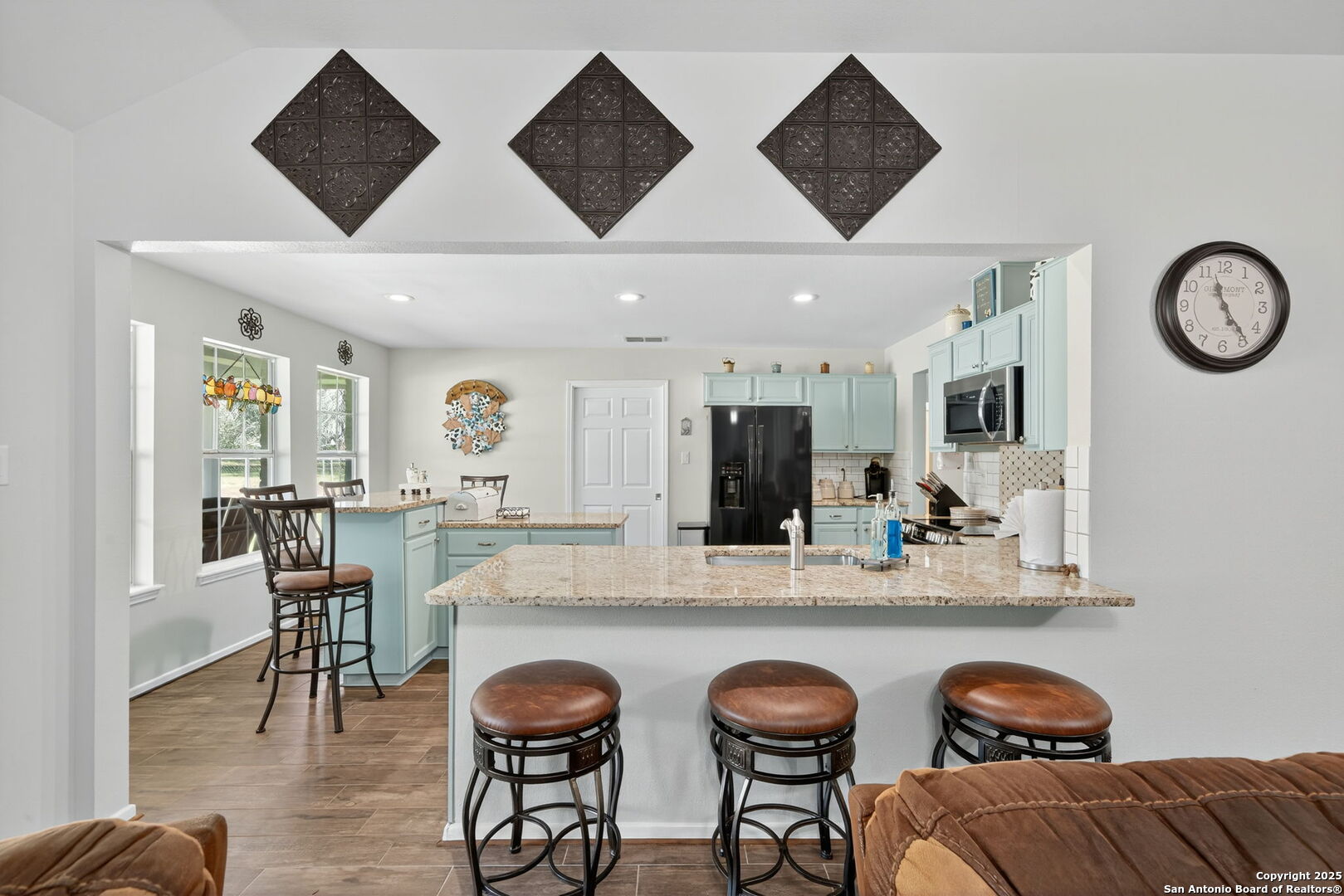231 Hayden Road Pleasanton, TX 78064 - Photo 14 of 36 a dining hall with stainless steel appliances kitchen island granite countertop furniture and a large window