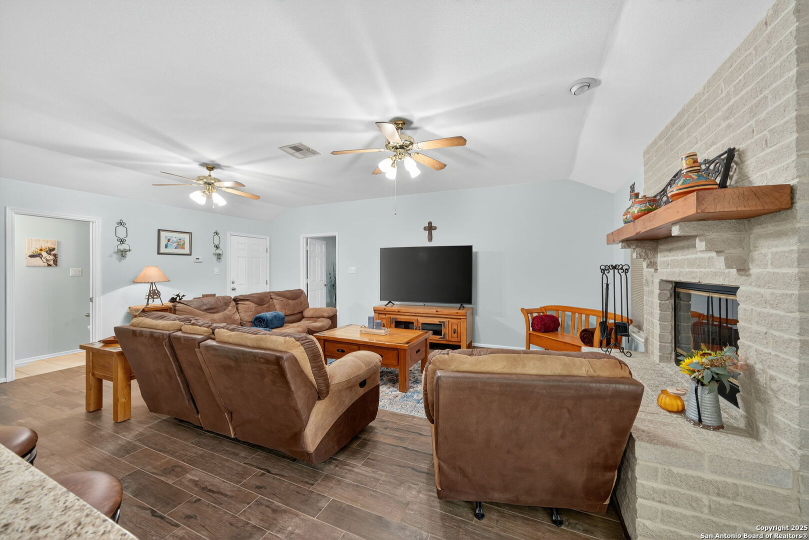 231 Hayden Road Pleasanton, TX 78064 - Photo 17 of 36 a living room with furniture a fireplace and a flat screen tv