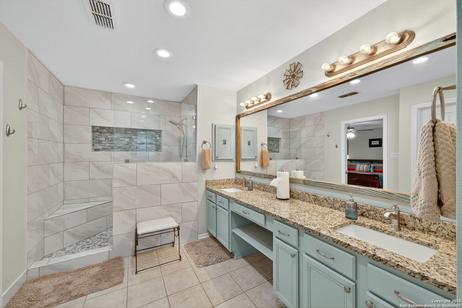 231 Hayden Road Pleasanton, TX 78064 - Photo 23 of 36 a spacious bathroom with a granite countertop double vanity sink a mirror and a shower