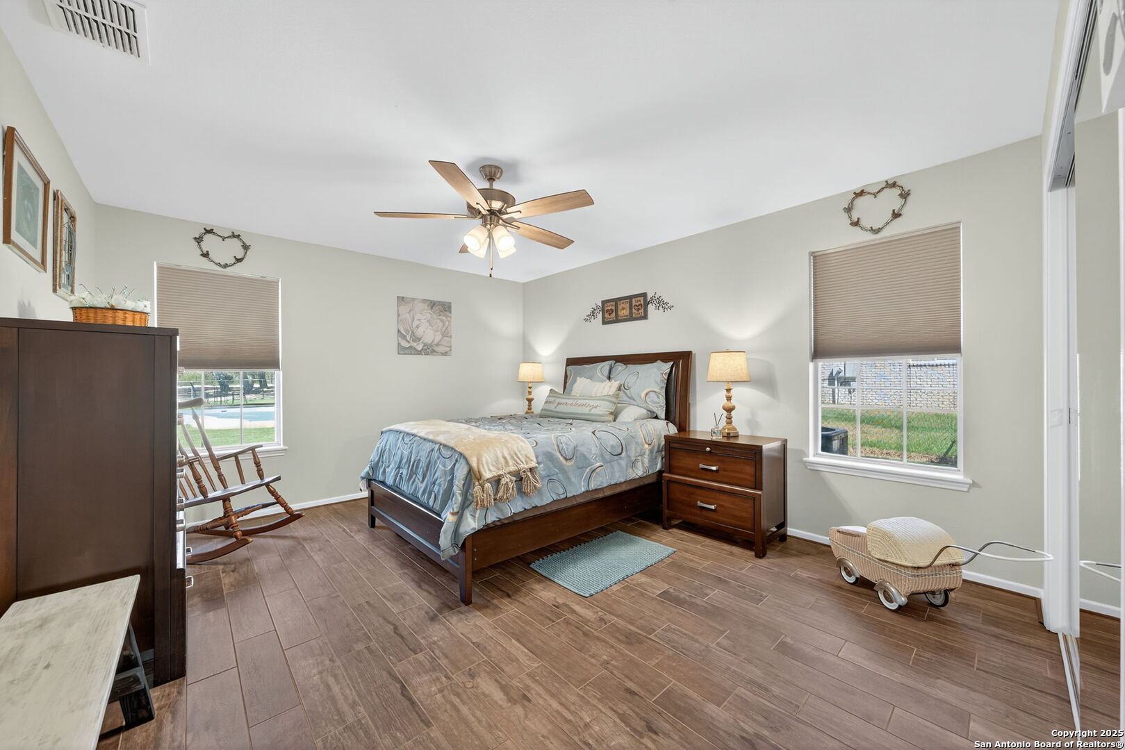 231 Hayden Road Pleasanton, TX 78064 - Photo 24 of 36 a bedroom with a bed and wooden floor