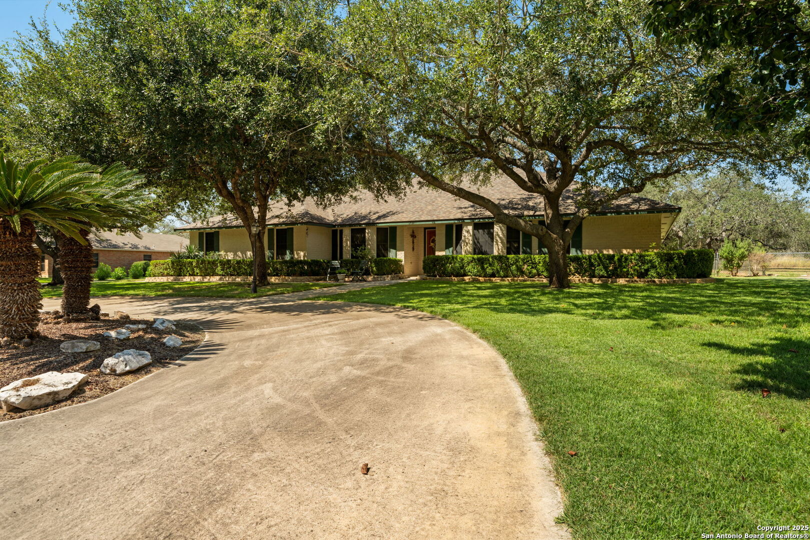 231 Hayden Road Pleasanton, TX 78064 - Photo 3 of 36 a front view of a building with trees