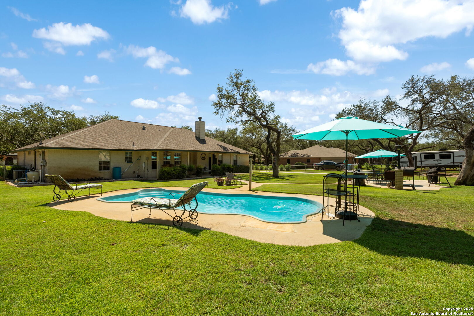 231 Hayden Road Pleasanton, TX 78064 - Photo 32 of 36 a swimming pool with outdoor seating and yard
