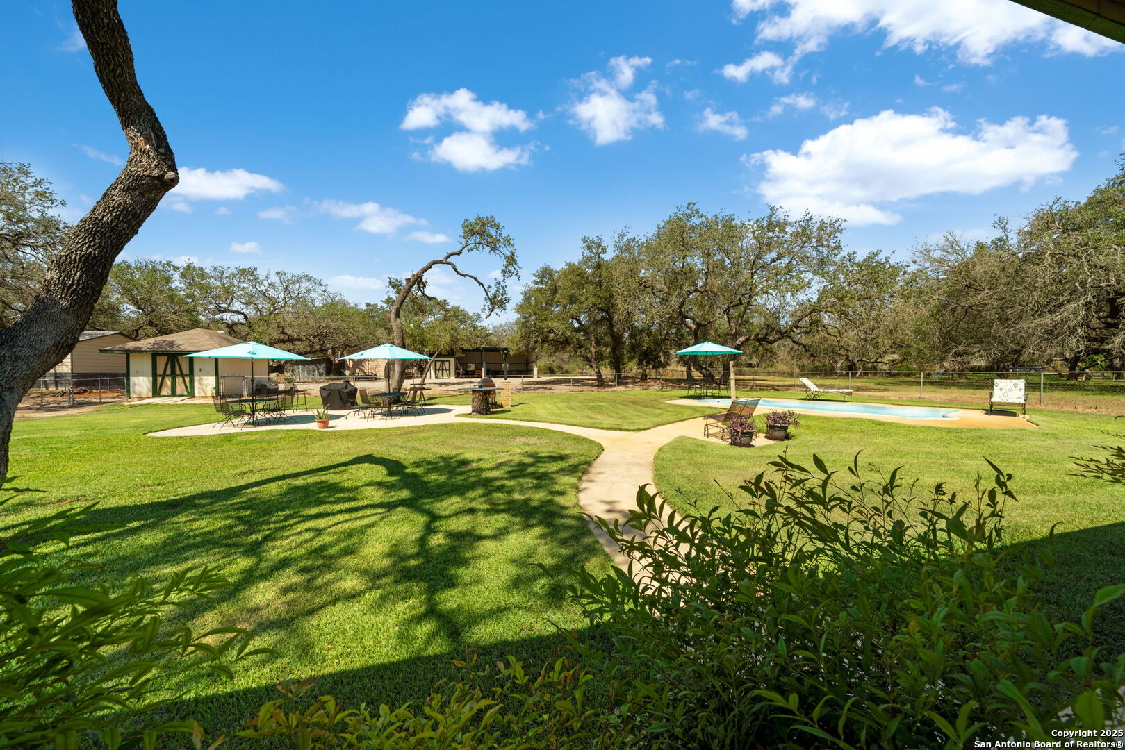 231 Hayden Road Pleasanton, TX 78064 - Photo 33 of 36 a view of swimming pool with outdoor seating and trees