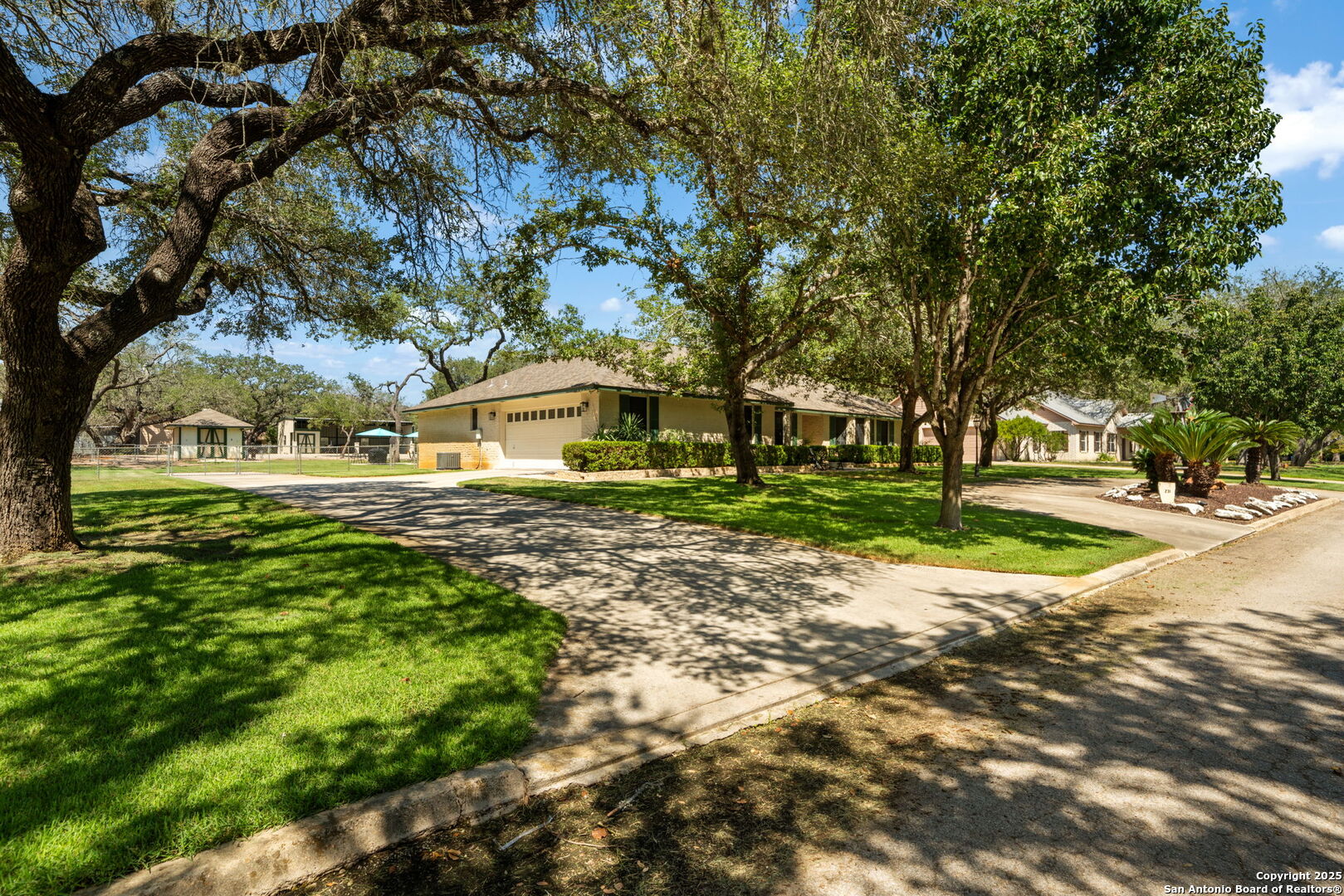 231 Hayden Road Pleasanton, TX 78064 - Photo 5 of 36 a view of a house with a big yard and large trees