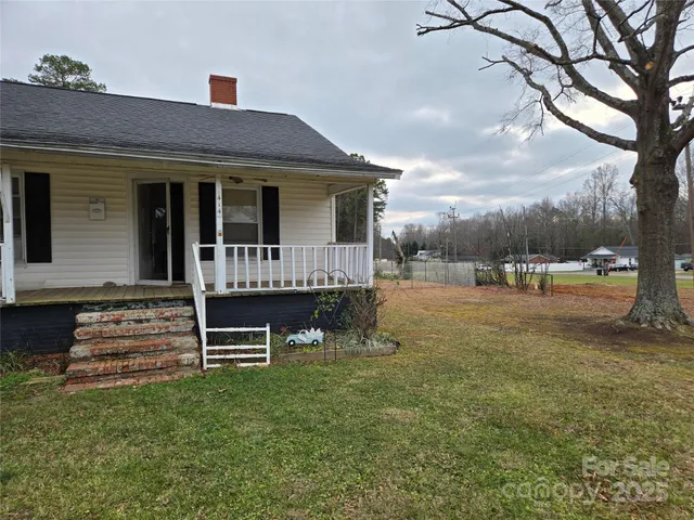 a front view of a house with a garden and yard