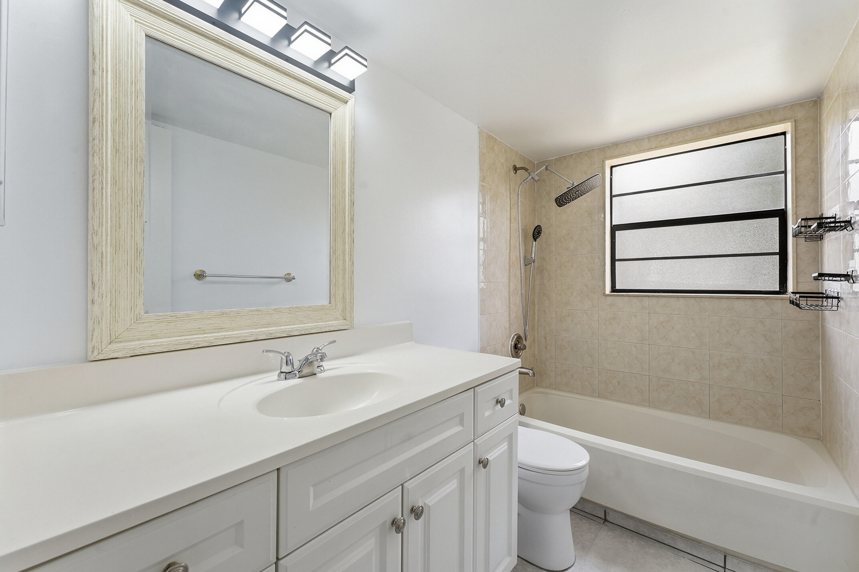 2671 Riverside Drive, Unit 1 Coral Springs, FL 33065 - Photo 11 of 25 a bathroom with a sink a toilet and shower