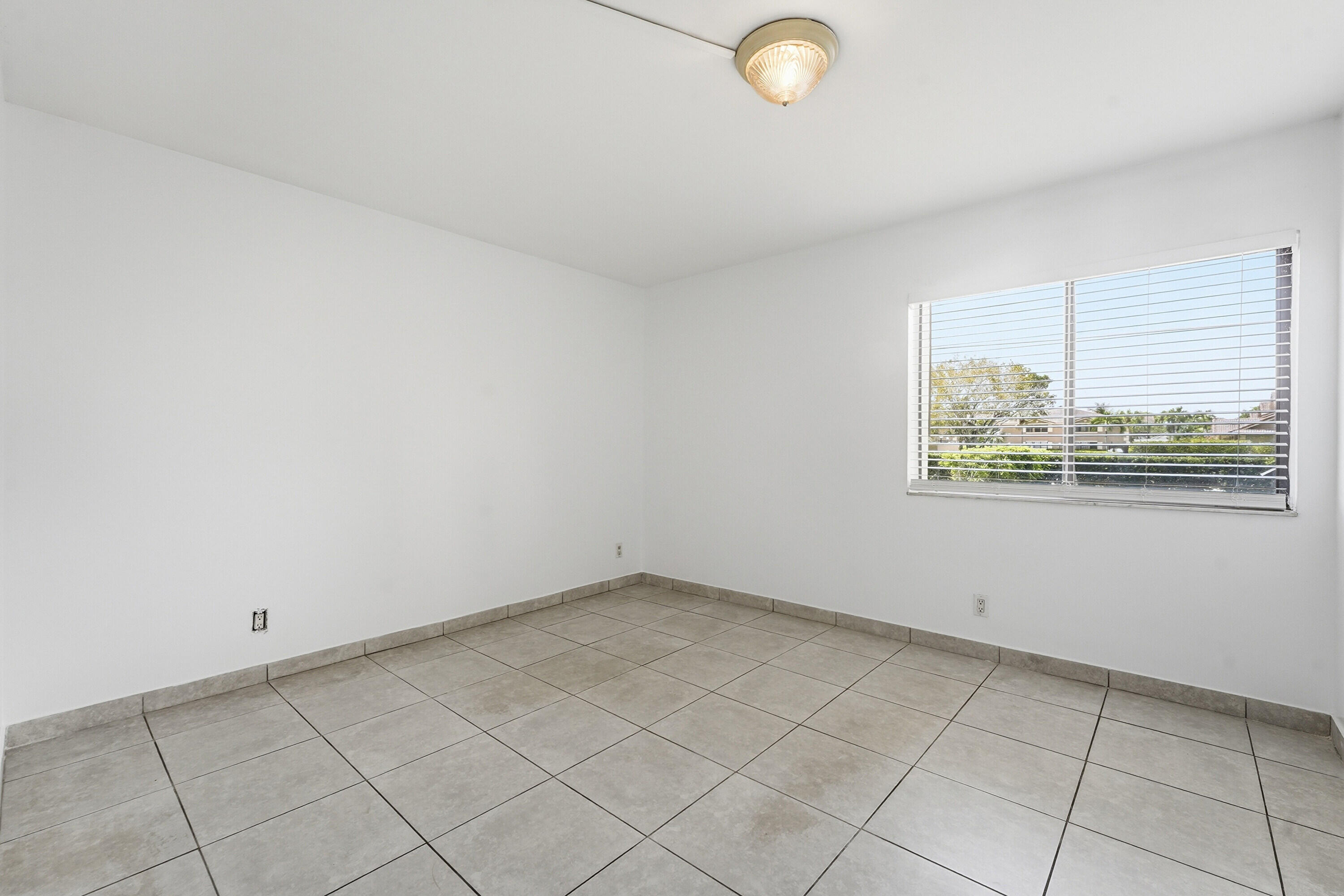 2671 Riverside Drive, Unit 1 Coral Springs, FL 33065 - Photo 12 of 25 an empty room with windows