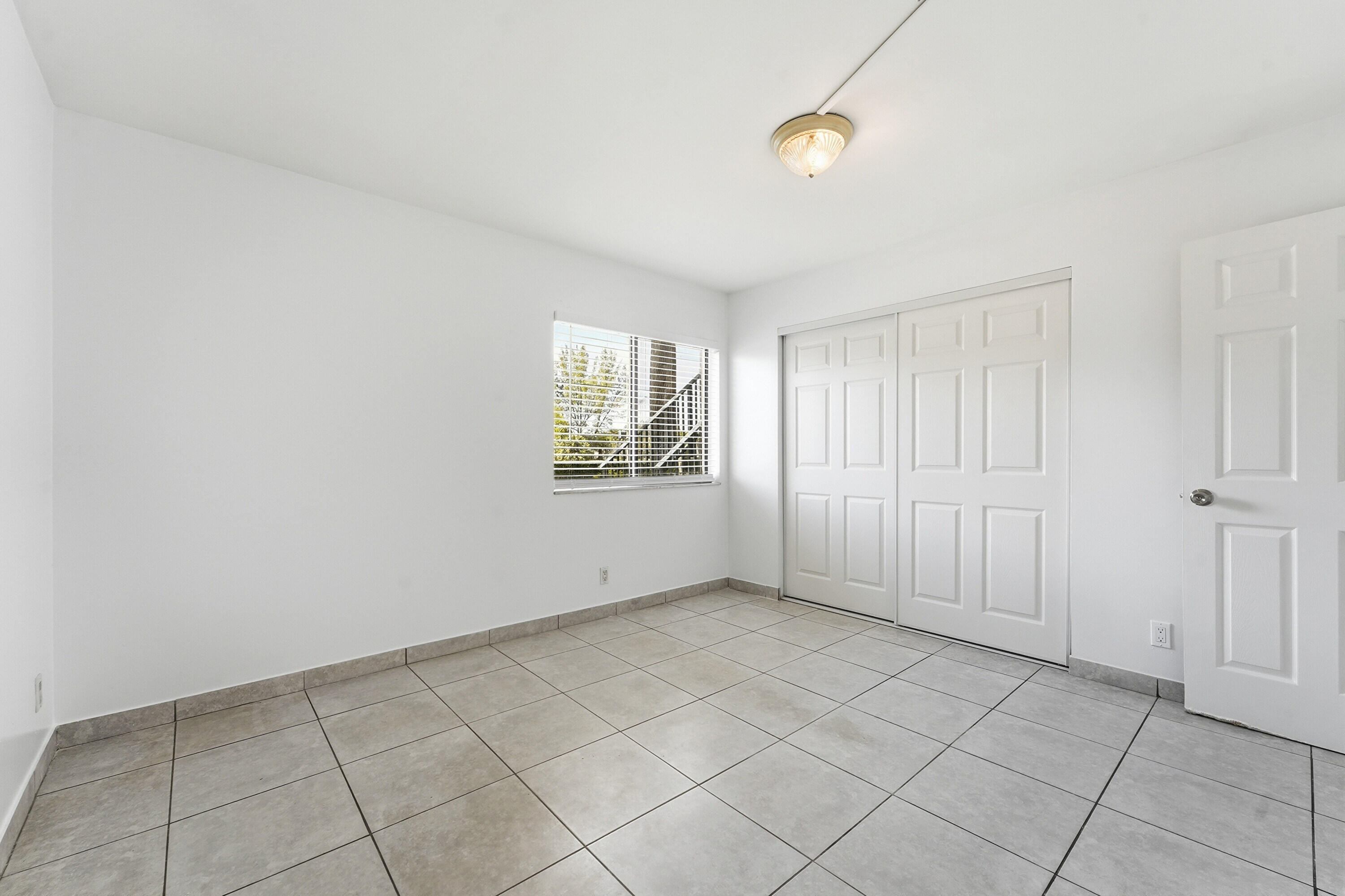 2671 Riverside Drive, Unit 1 Coral Springs, FL 33065 - Photo 14 of 25 a view of an empty room with window
