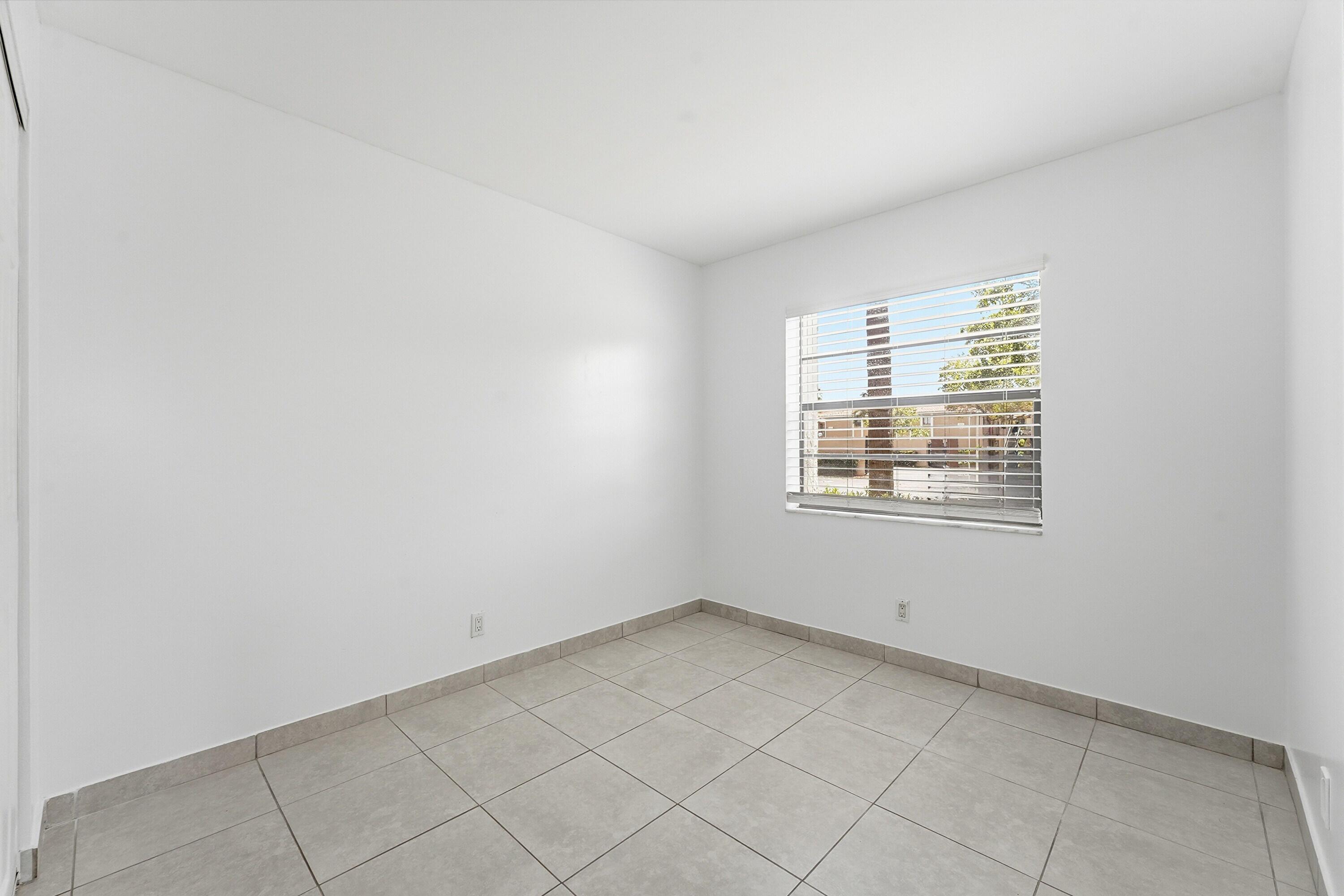 2671 Riverside Drive, Unit 1 Coral Springs, FL 33065 - Photo 15 of 25 an empty room with a window
