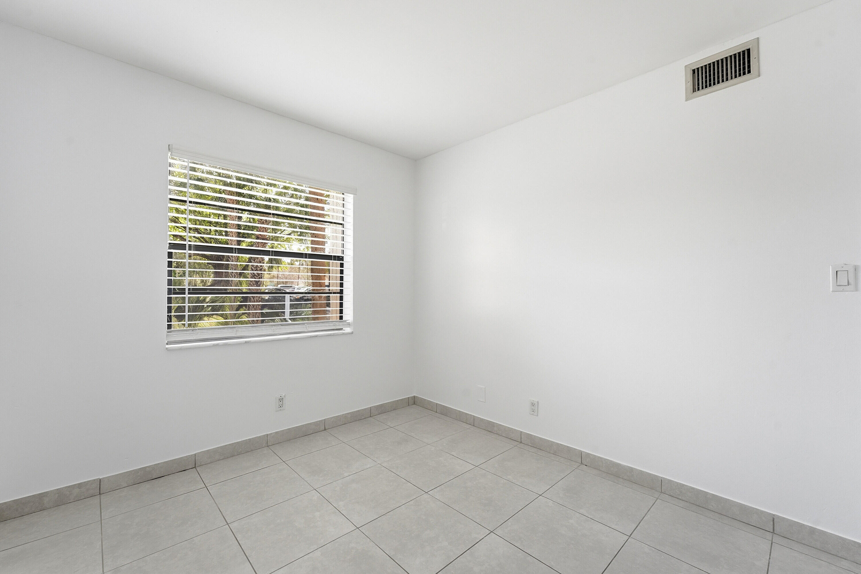 2671 Riverside Drive, Unit 1 Coral Springs, FL 33065 - Photo 17 of 25 a view of an empty room with a window