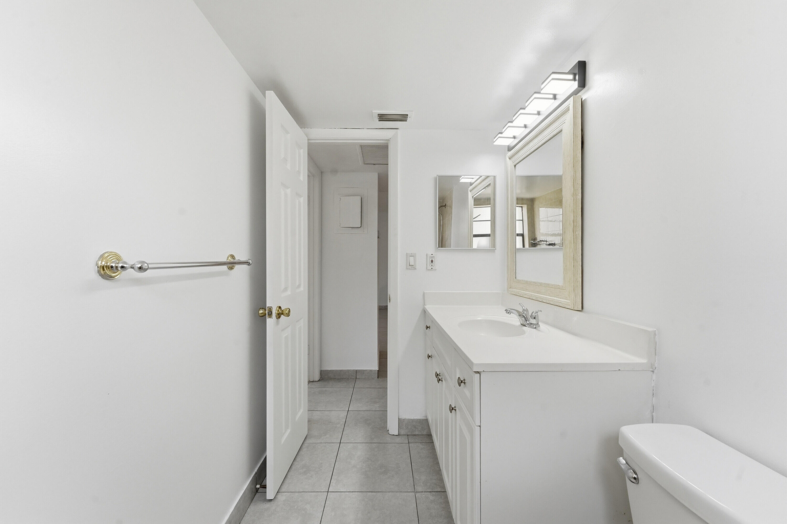 2671 Riverside Drive, Unit 1 Coral Springs, FL 33065 - Photo 19 of 25 a bathroom with a sink a toilet and shower
