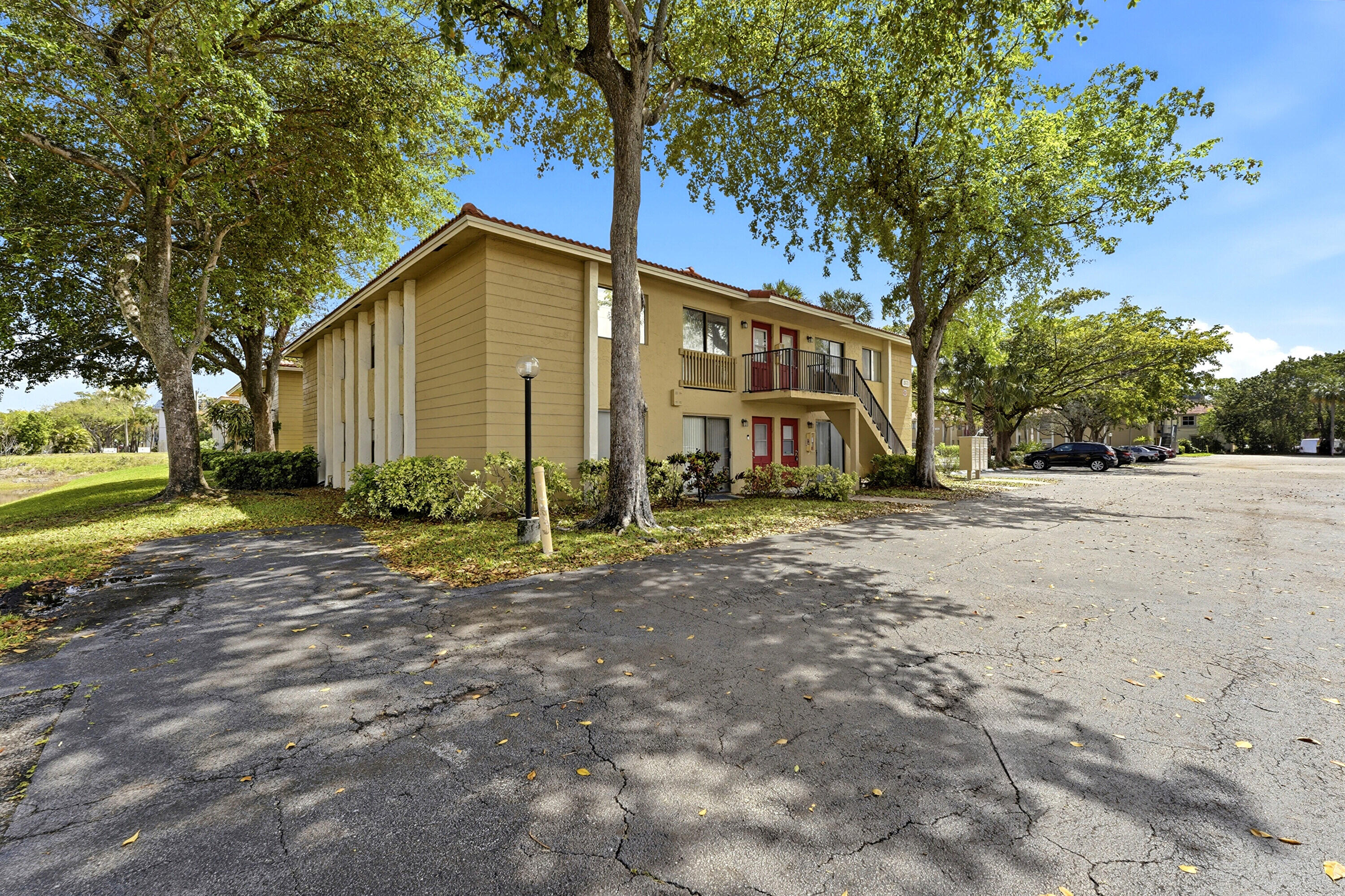 2671 Riverside Drive, Unit 1 Coral Springs, FL 33065 - Photo 2 of 25 a view of a house with backyard and trees