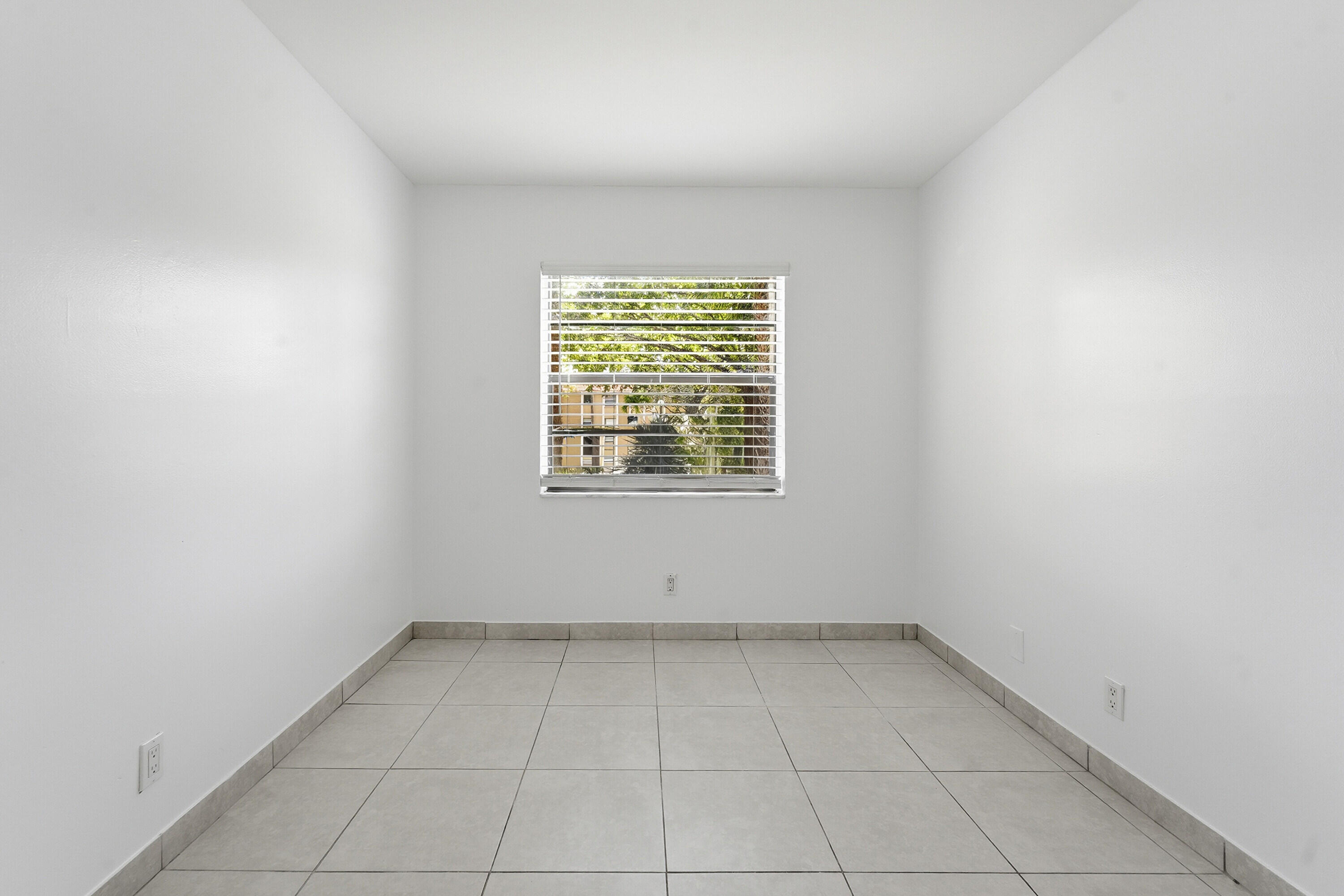 2671 Riverside Drive, Unit 1 Coral Springs, FL 33065 - Photo 21 of 25 an empty room with a window