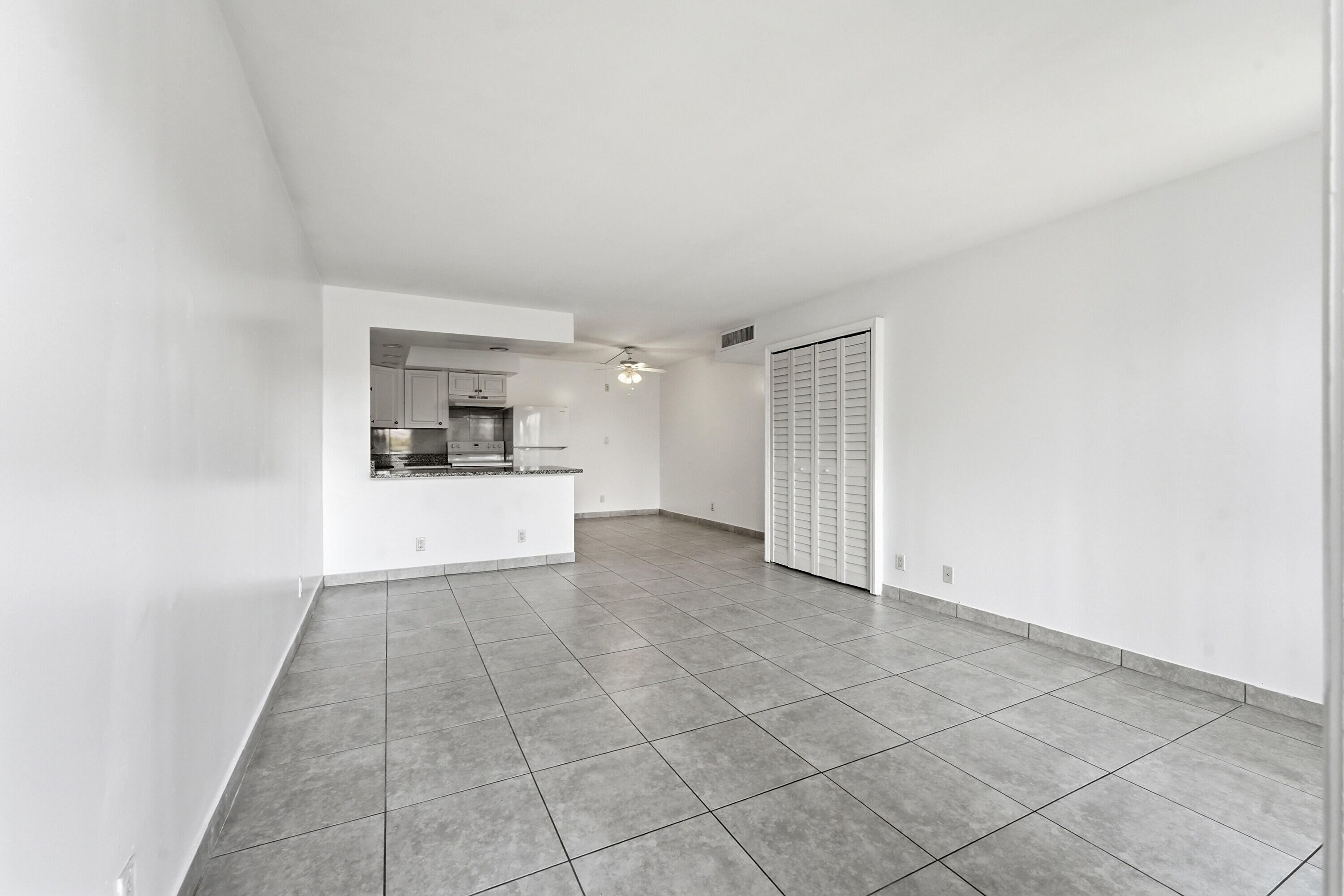 2671 Riverside Drive, Unit 1 Coral Springs, FL 33065 - Photo 3 of 25 a view of a kitchen with a sink and a refrigerator