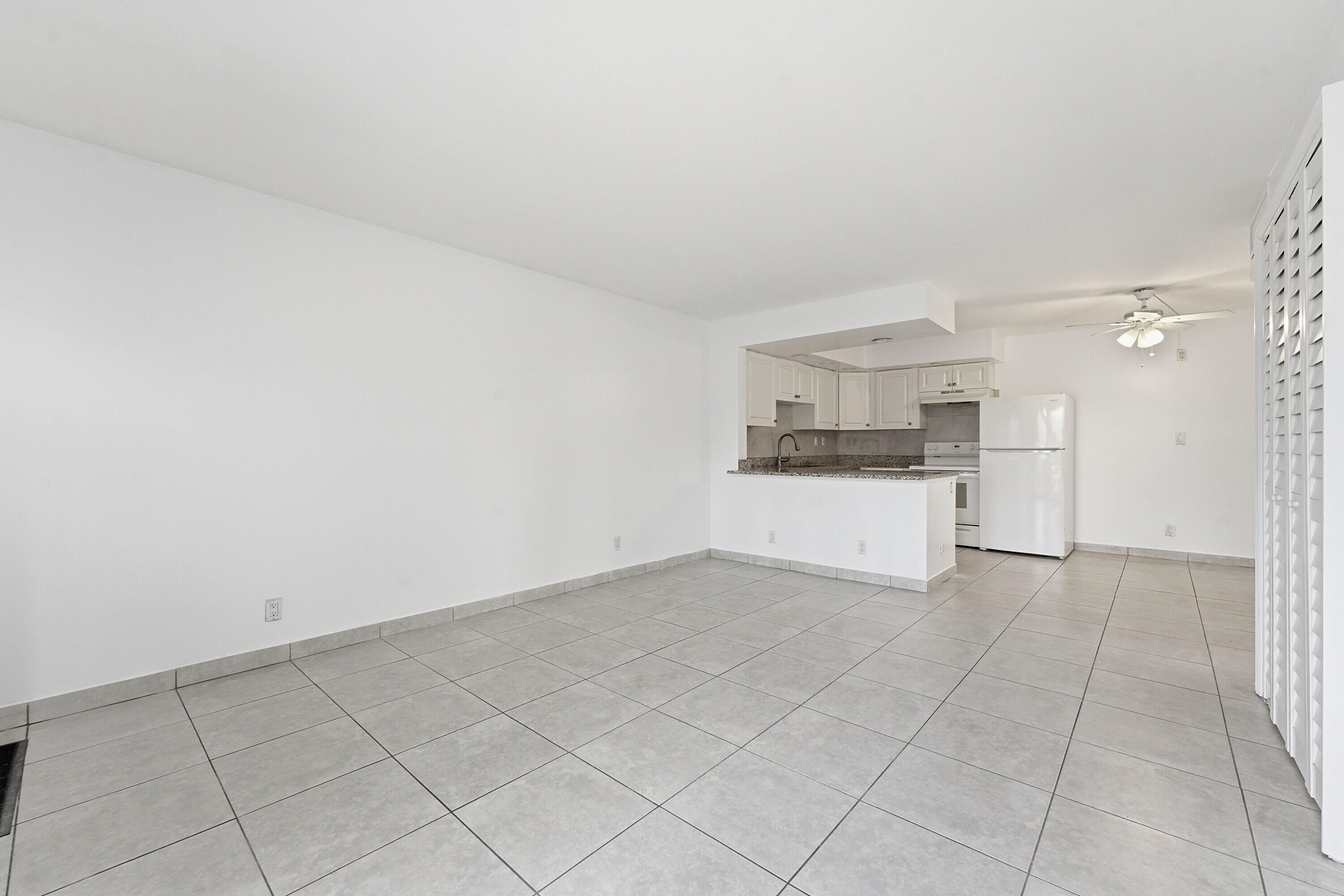 2671 Riverside Drive, Unit 1 Coral Springs, FL 33065 - Photo 4 of 25 a view of a kitchen with white cabinets