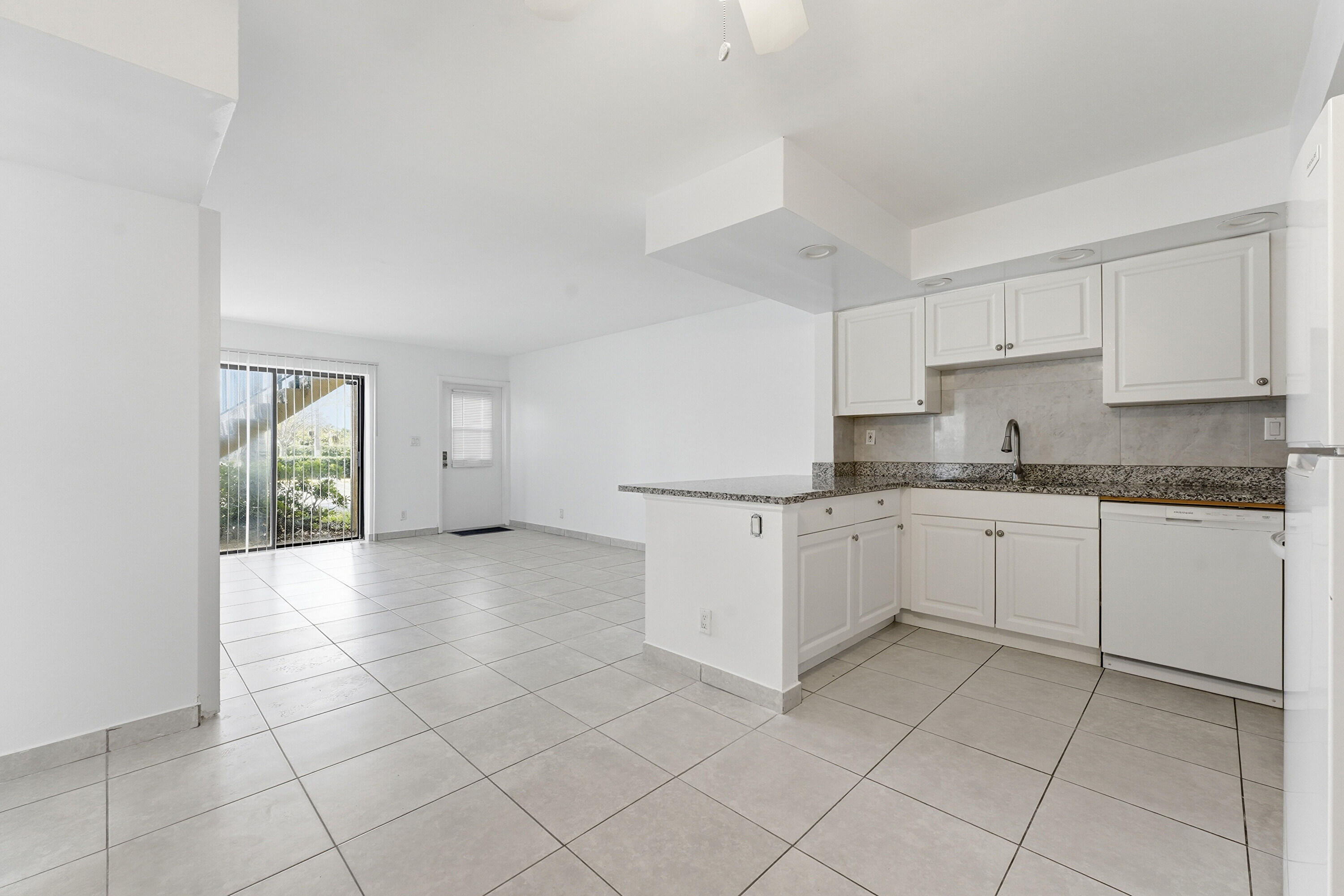 2671 Riverside Drive, Unit 1 Coral Springs, FL 33065 - Photo 6 of 25 a kitchen with a cabinets and window