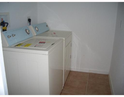 5929 Spanish River Road Fort Pierce, FL 34951 - Photo 4 of 8 a utility room with dryer and washer
