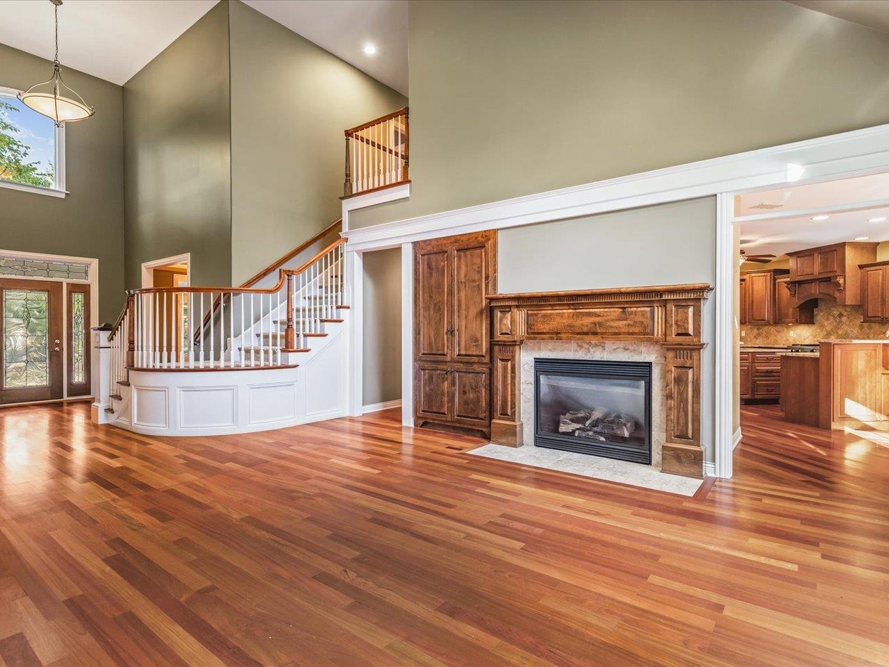 12936 Melrose Road Caledonia, IL 61011 - Photo 14 of 94 an empty room with wooden floor fireplace and windows