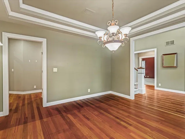 an empty room with closet and a ceiling fan
