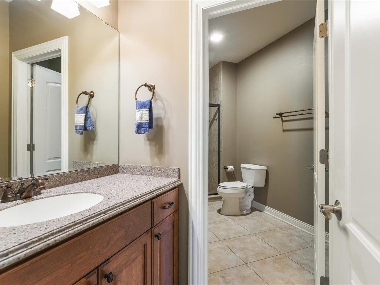 12936 Melrose Road Caledonia, IL 61011 - Photo 51 of 94 a bathroom with a granite countertop sink toilet and shower